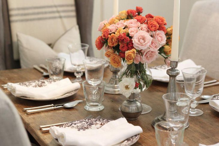 Curved flower glass centerpiece on a cherrywood dining table