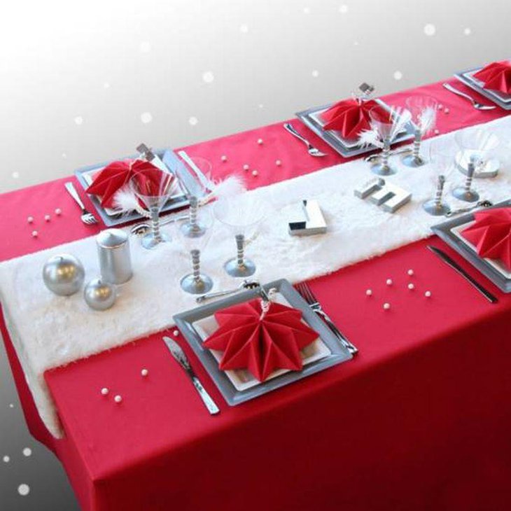 Cute Christmas Tablescape With Red Tablecloth and Napkins With Silver Decorative Pieces