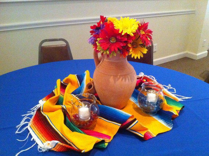 Cute earthen vase centerpiece with flowers