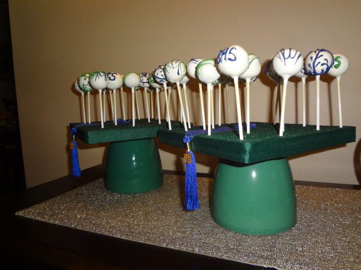 Cute green graduation cake pops centerpiece