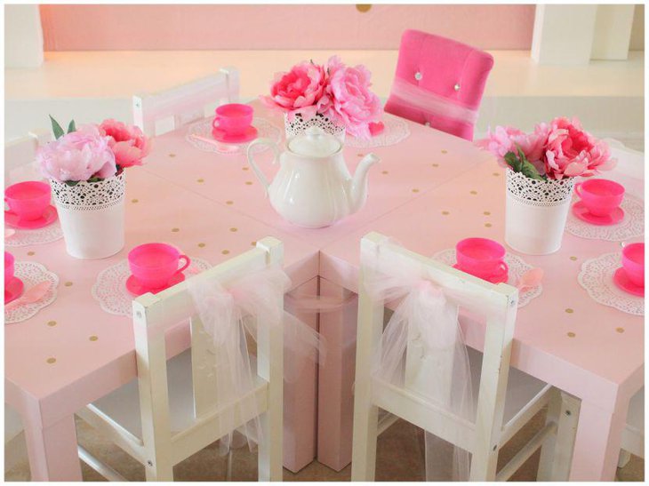 Cute pink and white table setup for princess baby shower