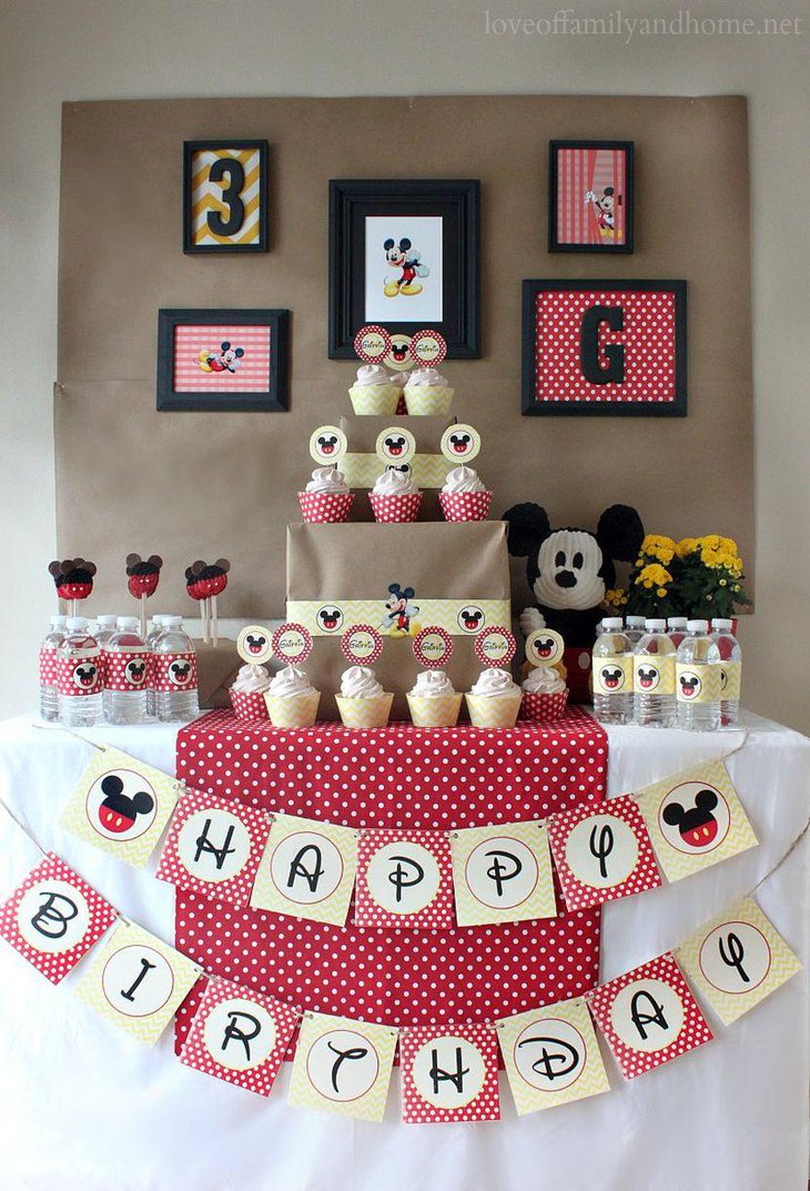 Cute pink polka dotted Mickey Mouse themed birthday dessert table