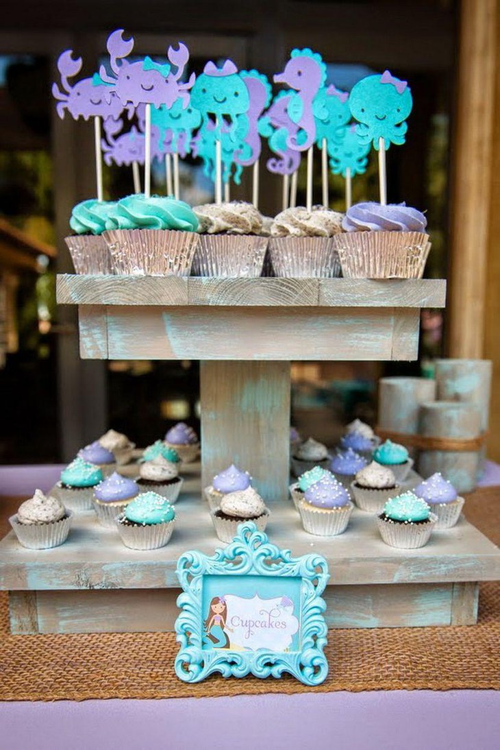 Cute vintage mermaid baby shower table decor with cupcakes