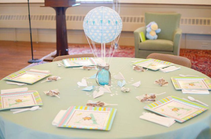 Decorative mason jar baby shower centerpiece with balloon and string detailing