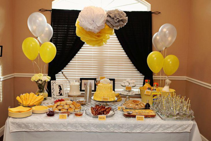 Delectable yellow and grey themed buffet spread for baby shower