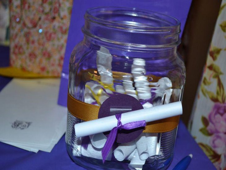 DIY graduation day party table decor with purple ribbon and tablecloth