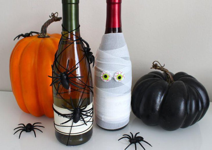DIY Halloween wine bottles decorated with spiders and bandage