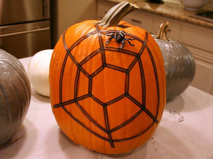 DIY spiderweb decor on a pumpkin