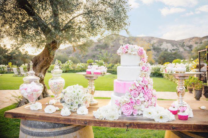 DIY wedding candy cake table idea with pink floral accents