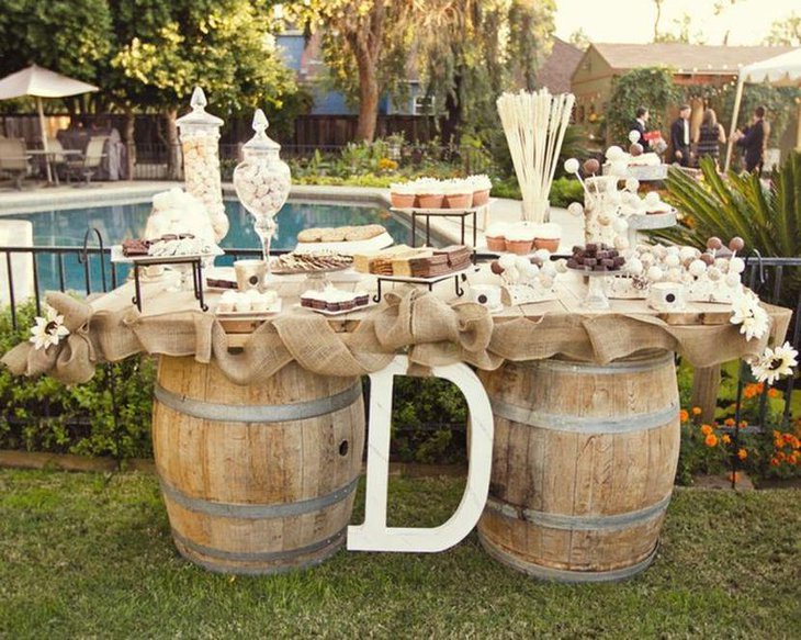 DIY wedding candy table idea with barrels and burlap
