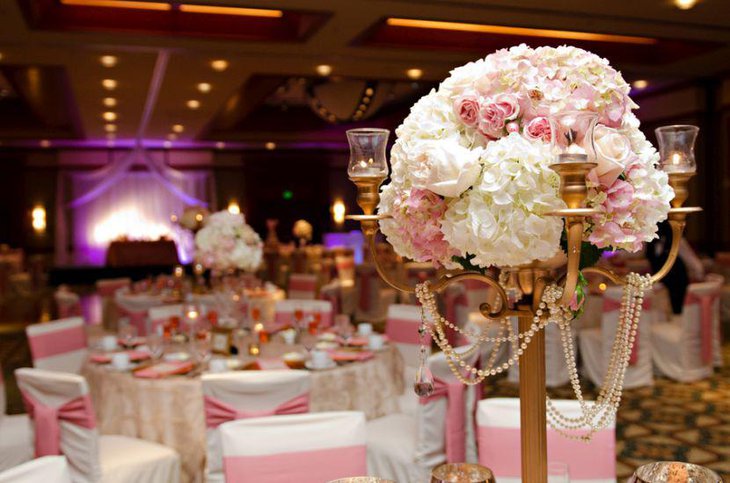 Elegant golden candelabra with flowers decor on wedding table
