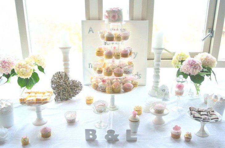 European wedding dessert table with flowers as decoration