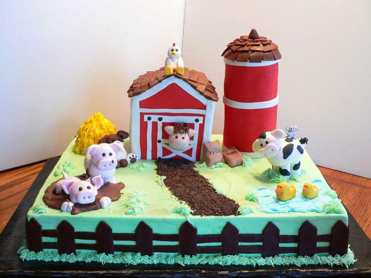 Fantastic farm themed first birthday cake decor on table