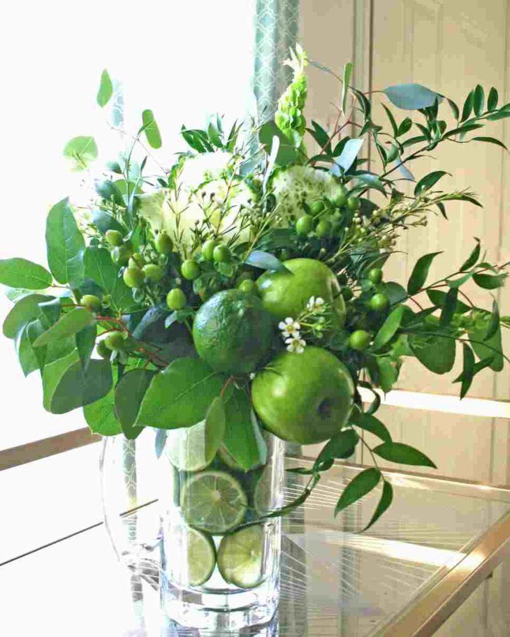 Fruit and leaves in glass vase for St Patricks Day table centerpiece