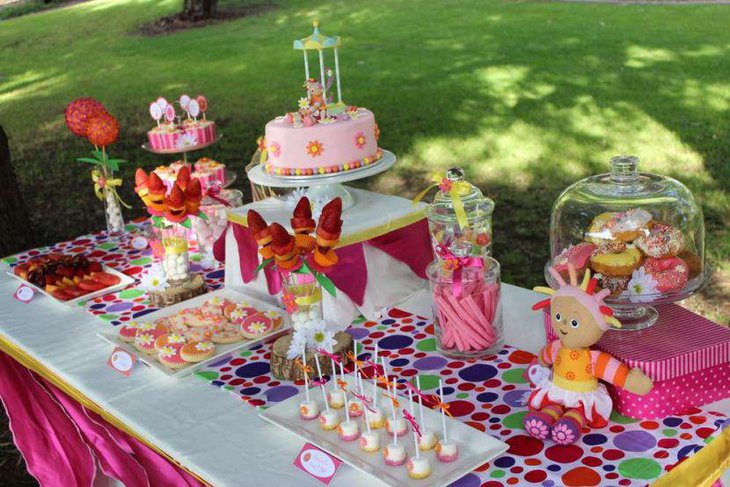 Garden birthday table adorned with colourful embellishments
