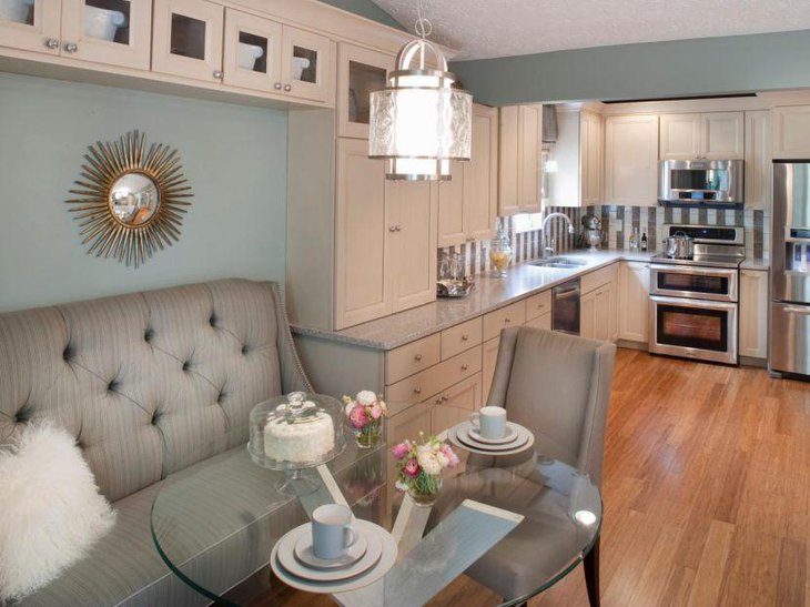 Glass breakfast nook table with sofa at kitchen corner