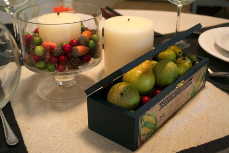 Glass Goblet with Candle Berries Pines and Acorns As Table Centerpiece