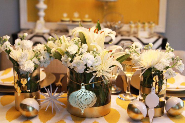 Golden accented table decor with flowers and Christmas baubles