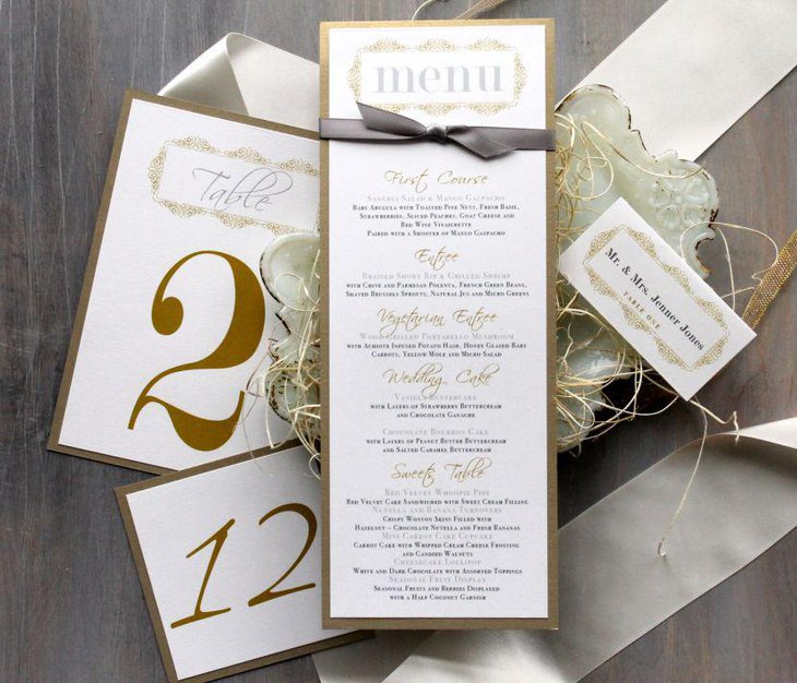 Golden accented wedding menu cards on table