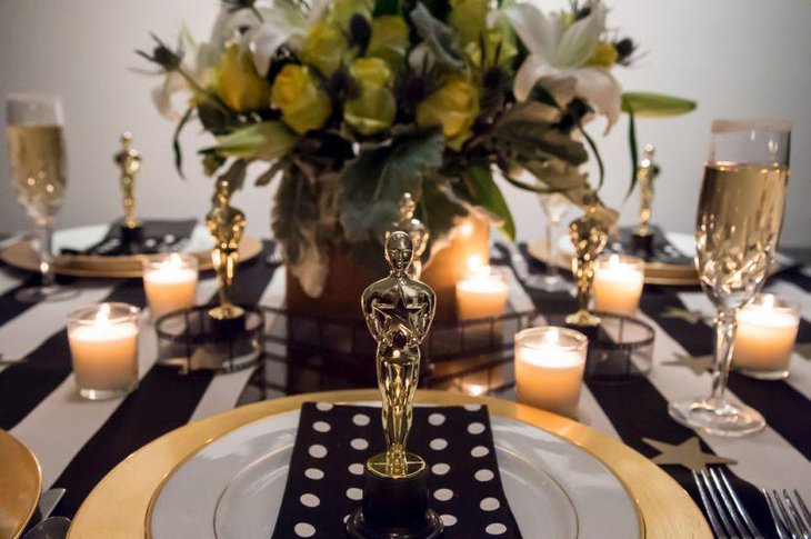 Golden Oscar statues seen decking up this dinner party table