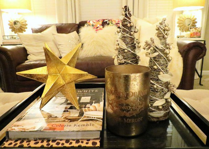 Golden star and silver conical trees vignette on a coffee table