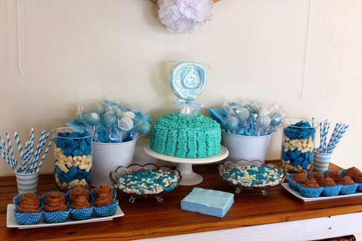 Gorgeous baby shower candy table decorations with blue accented candies and cake