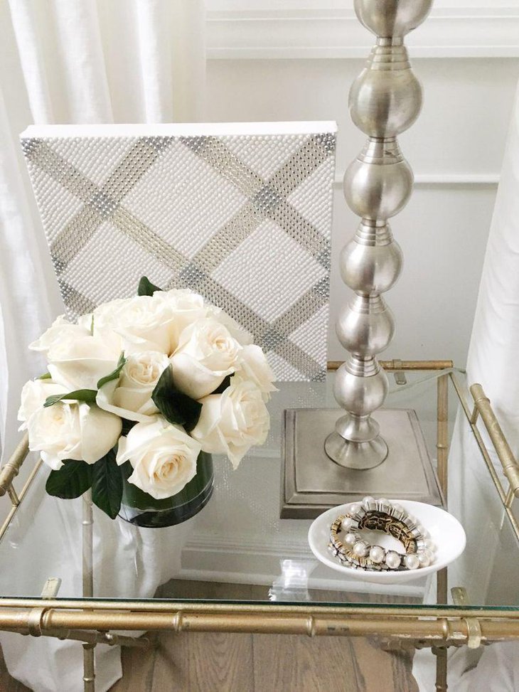 Gorgeous bedside table gussied up with flowers and jewelry filled dish