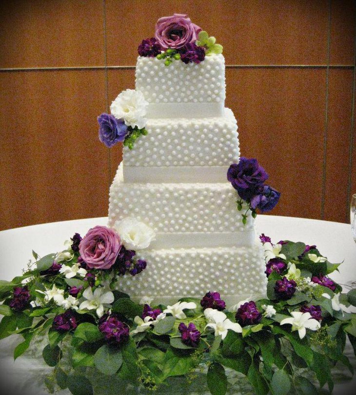 Gorgeous cake table decor with purple flowers