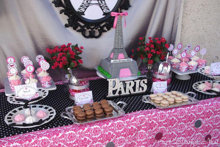 Gorgeous Eiffel Tower cake centerpiece on a birthday table