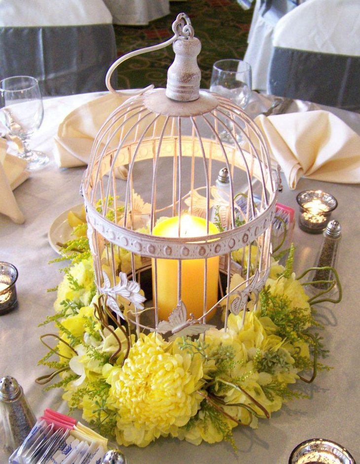 Gorgeous floral and candle accented wedding birdcage centerpiece