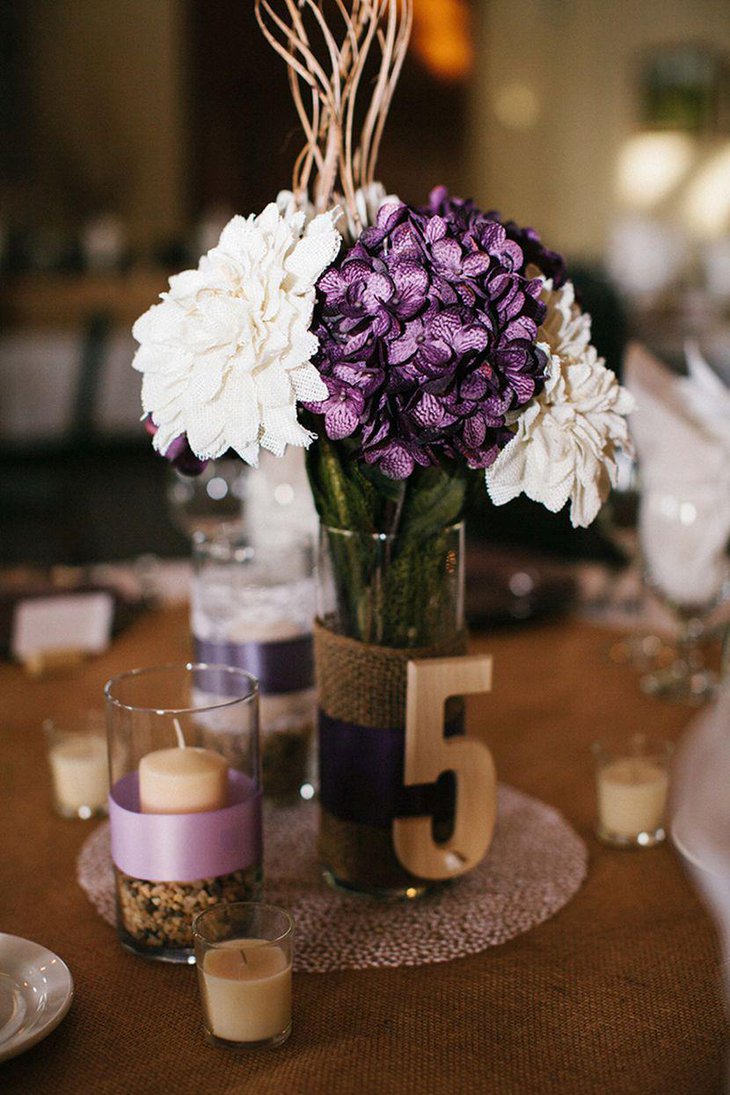 Gorgeous purple and white floral arrangement on a country wedding table