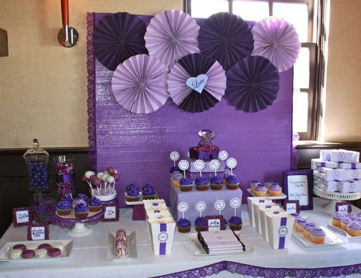 Gorgeous purple bridal shower dessert table decor with pin wheel backdrop