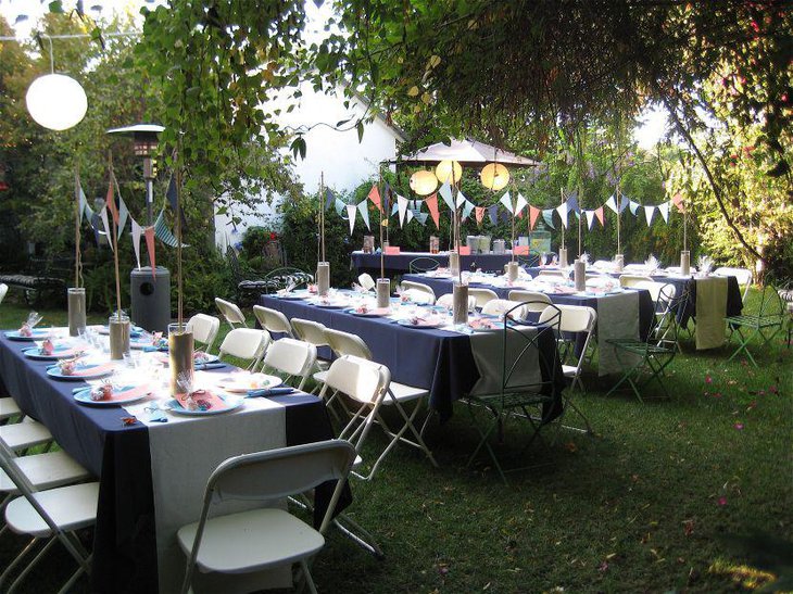 Gorgeous sand filled jar centerpieces on 80th birthday table