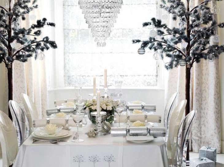 Gorgeous silver sconces with white candles on table