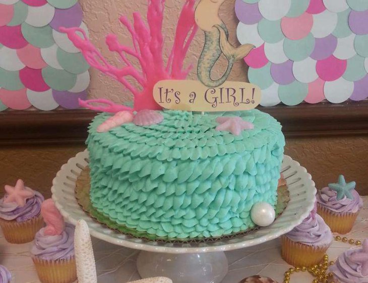 Gorgeous vintage mermaid baby shower table decoration with mermaid themed cake