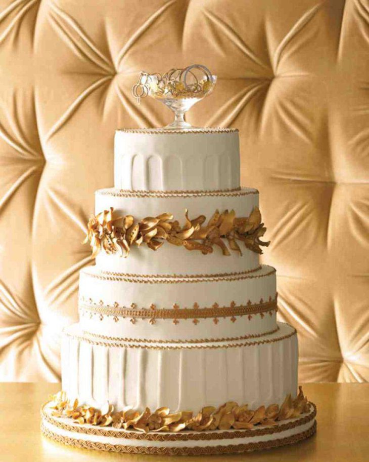 Gorgeous wedding cake decor with golden flowers and foliage