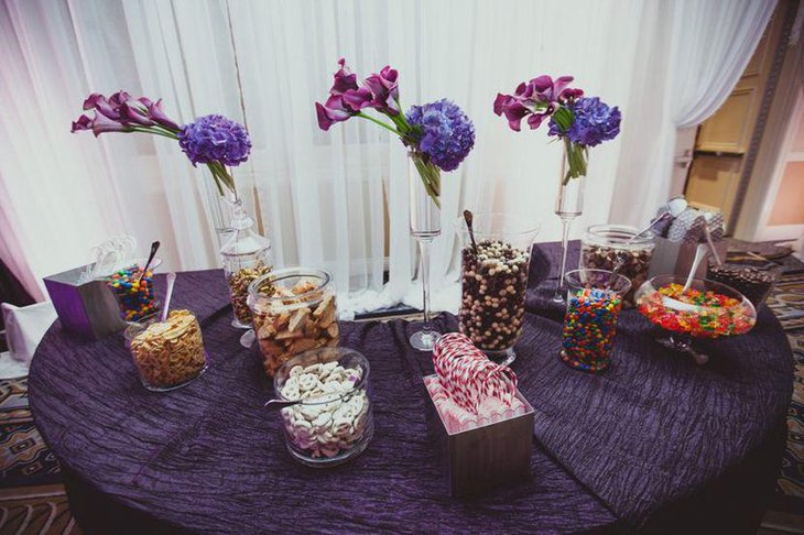 Gorgeous wedding candy table decor with purple tones