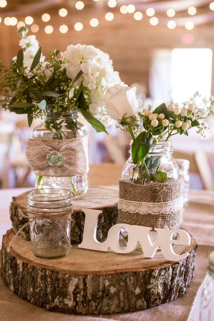 Gorgeous wooden centerpiece on a country wedding table