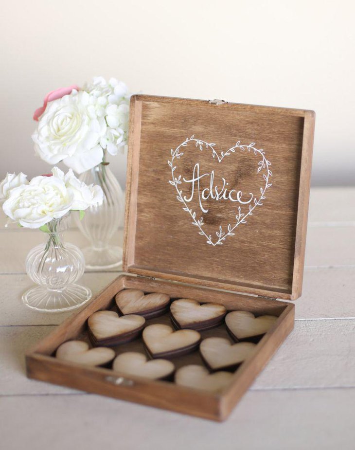 Gorgeous wooden chocolate box and floral vases deck up this country wedding table