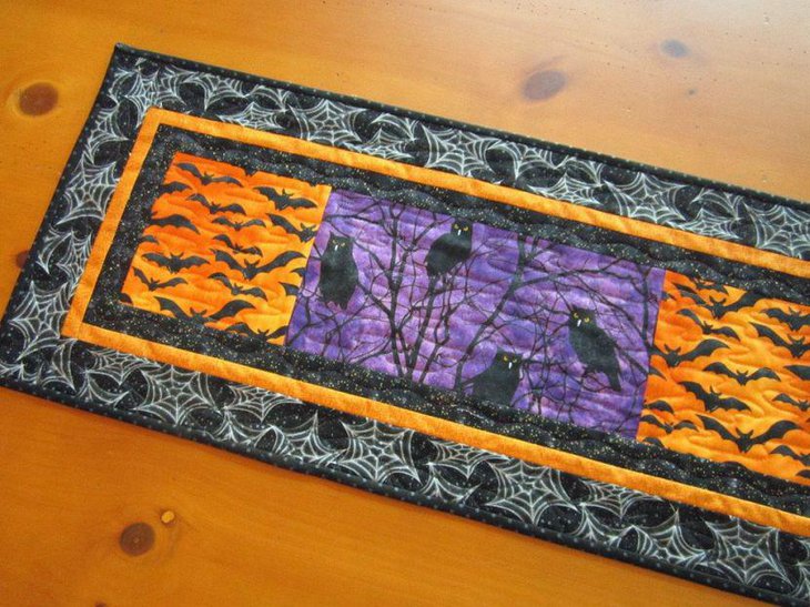 Handmade quilted table runner with bats and owls