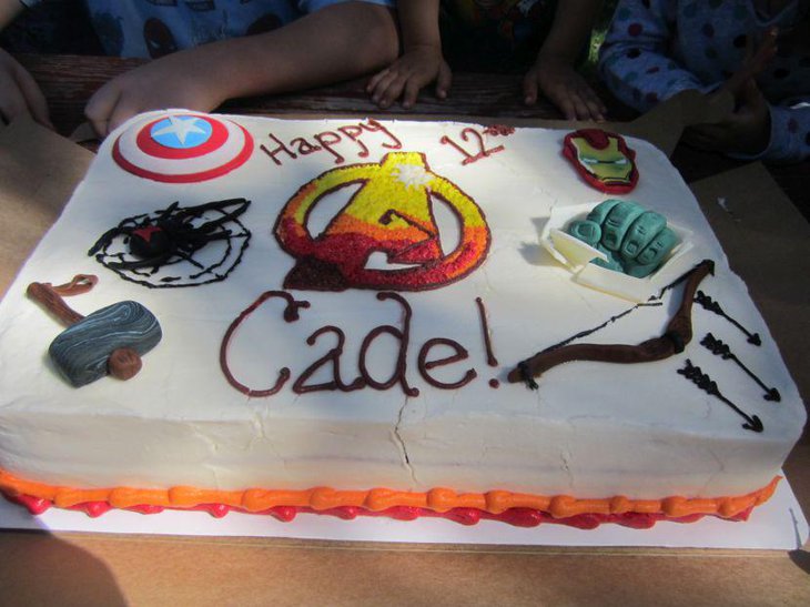 Huge Avengers cake displayed on boys birthday table