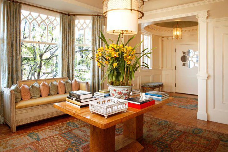 Innovative coffee table decor with huge flower pot books and white tray