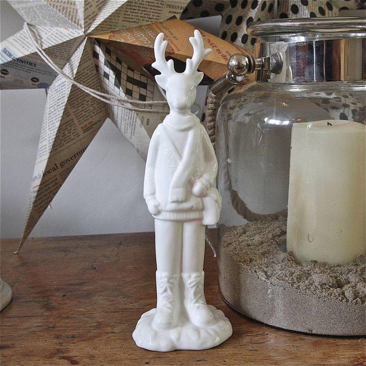 Innovative white ceramic reindeer and glass jar as coffee table centerpiece