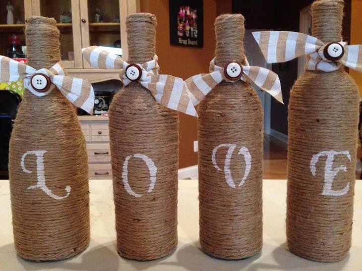 Letters Imprinted Wine Bottle Centerpieces Wrapped In Twine