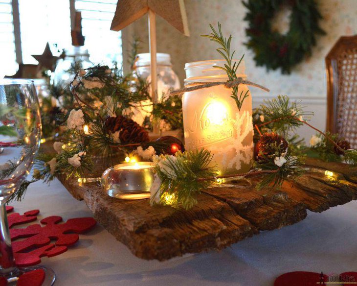 Lit up white mason jars on a wooden log offer the perfect ambiance