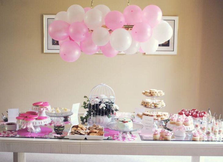 Lovely white and pink accents on bridal shower dessert table