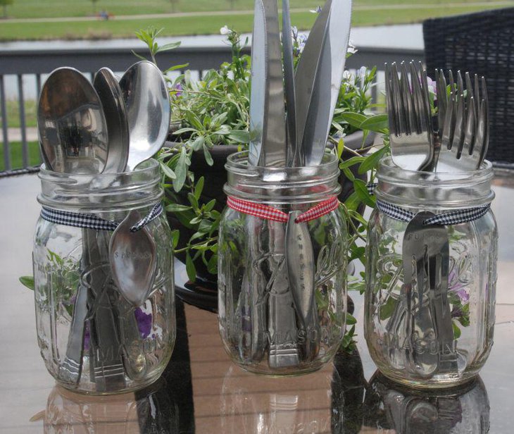 Mason jar holding cutlery for a rustic table setup