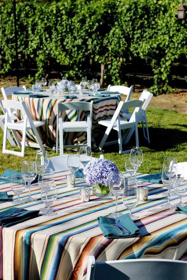 Mexican wedding table decorated with serapes and flowers