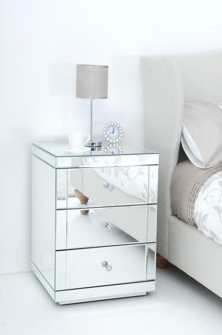 Mirrored bedside table decorated with a decorative clock