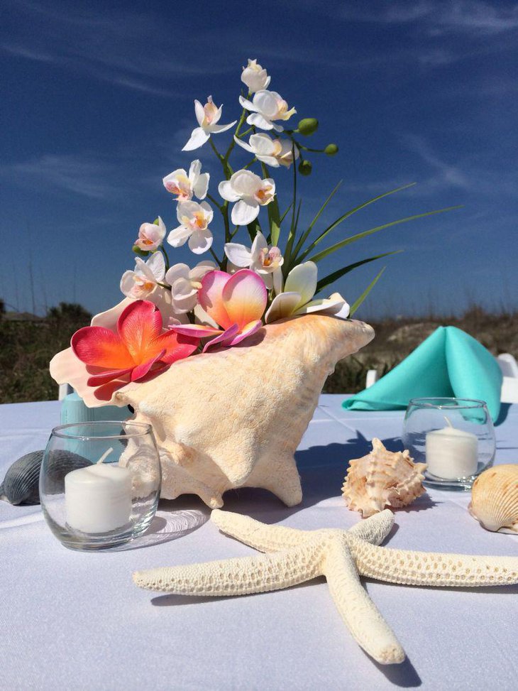 Orchid and conch shell wedding table centerpiece